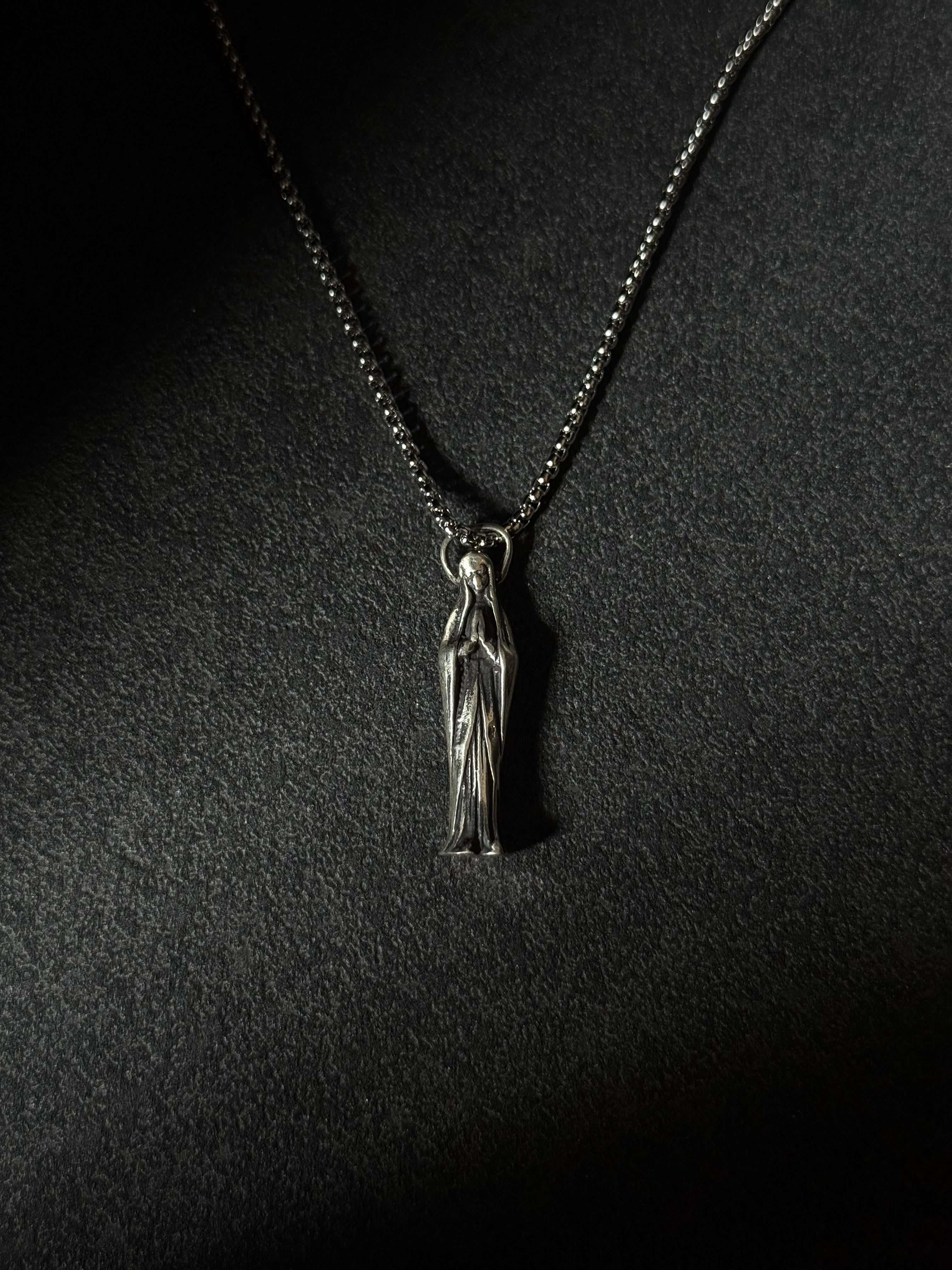 Handcrafted oxidized sterling silver Virgin Mary pendant necklace on a silver chain.