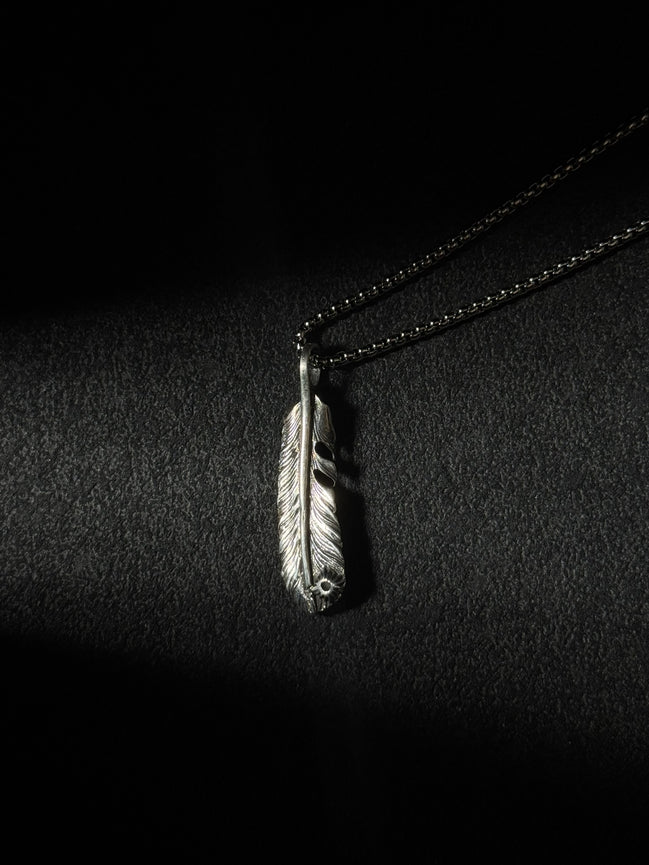 Handcrafted oxidized sterling silver feather pendant necklace with engraved feather details.