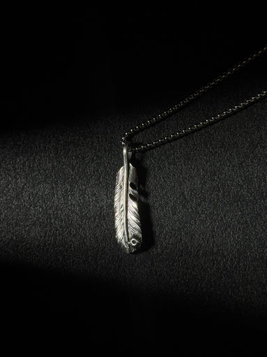 Handcrafted oxidized sterling silver feather pendant necklace with engraved feather details.